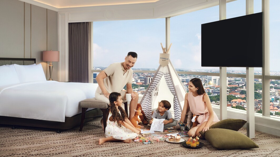A family in 1 king size guestroom with nice city v