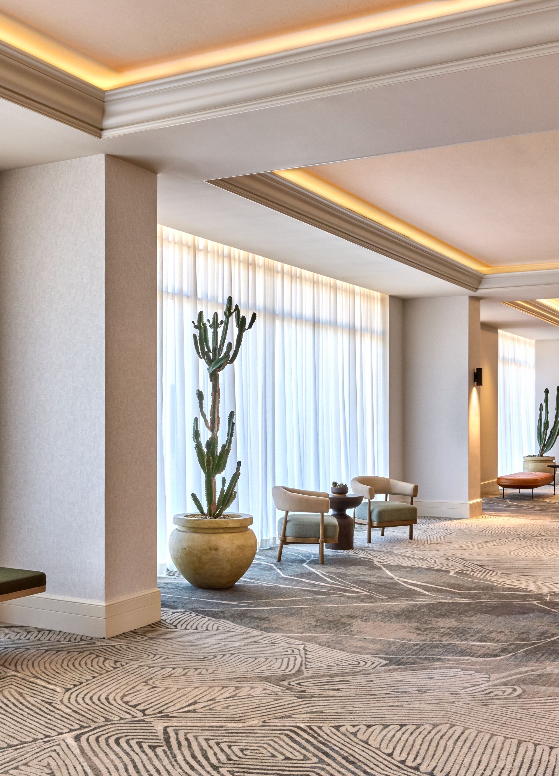 Hotel foyer with seating area and mountain views