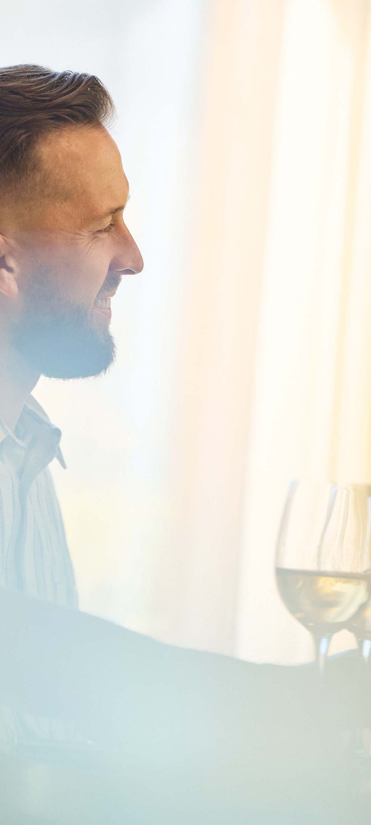 Person holding drink by window