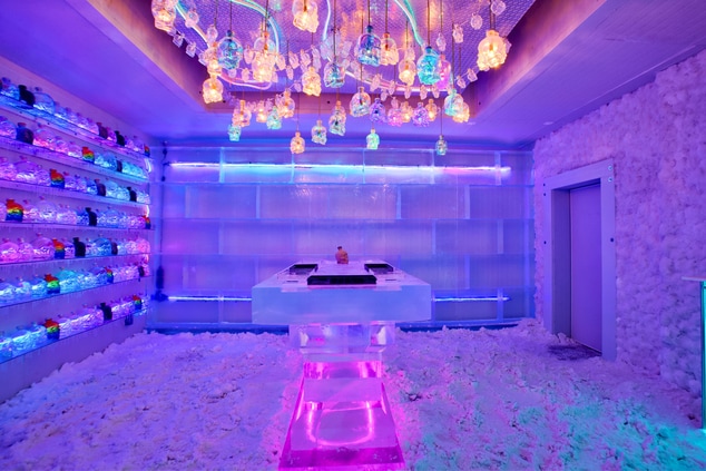 An icebar with seating and beautiful lighting