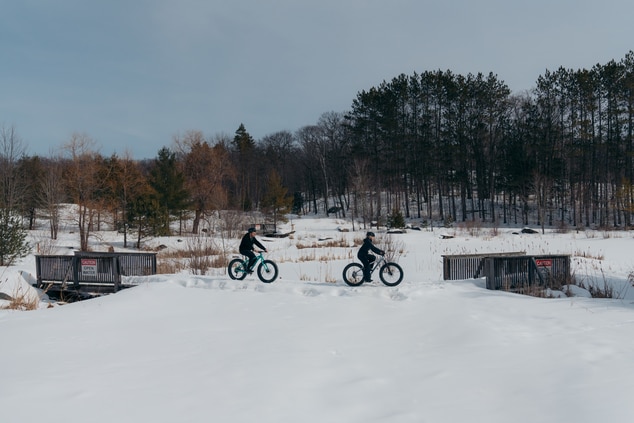 Explore the property grounds on fat bikes in winte