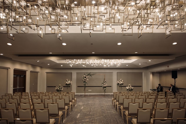 Ballroom with chairs and floral backdrop