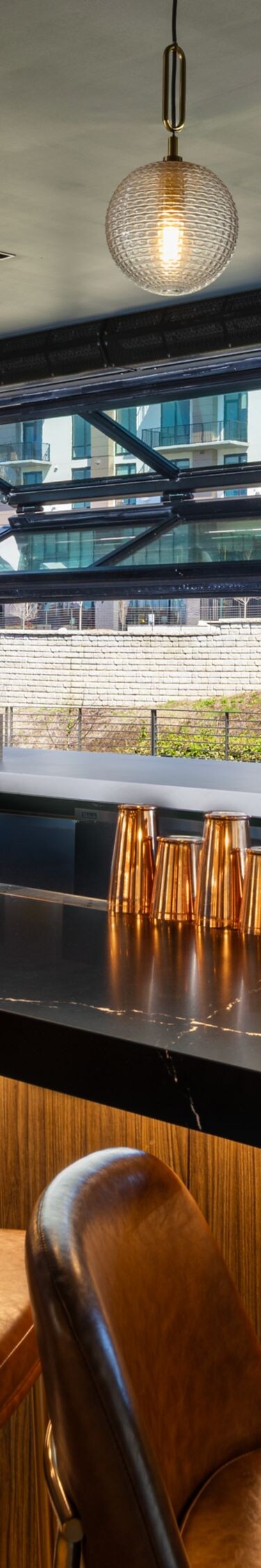 Modern bar with stools and backlit liquor shelves