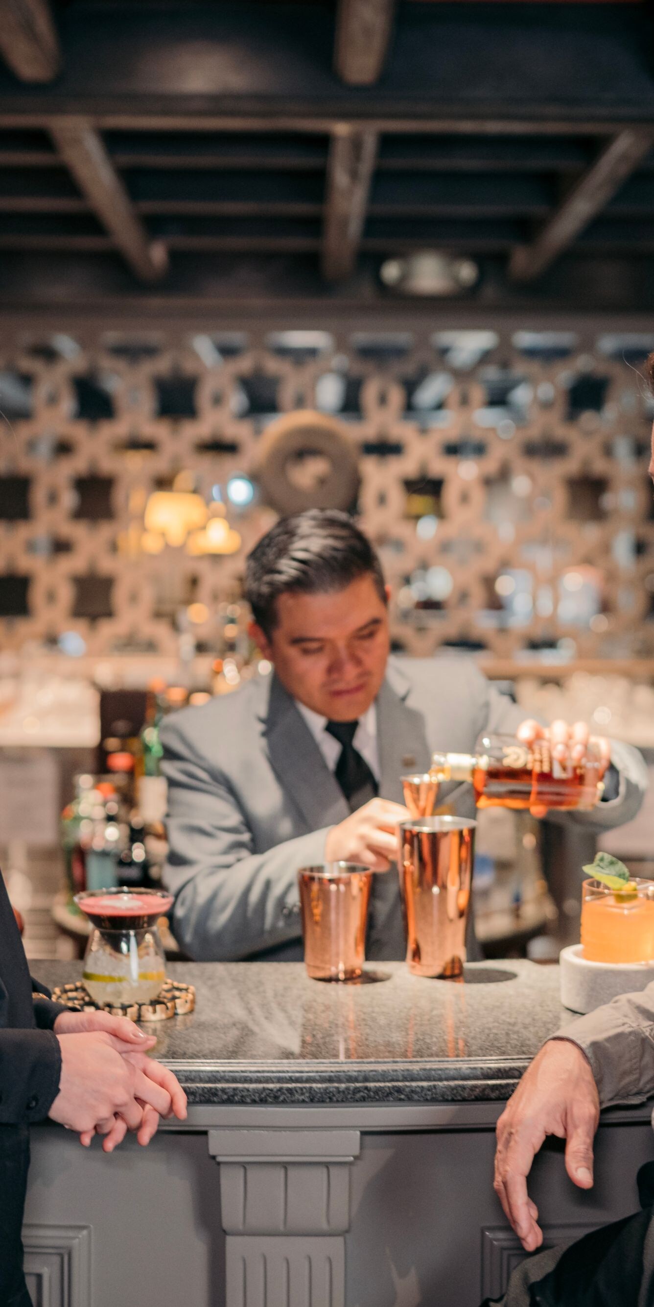 Couple getting cocktails at bar