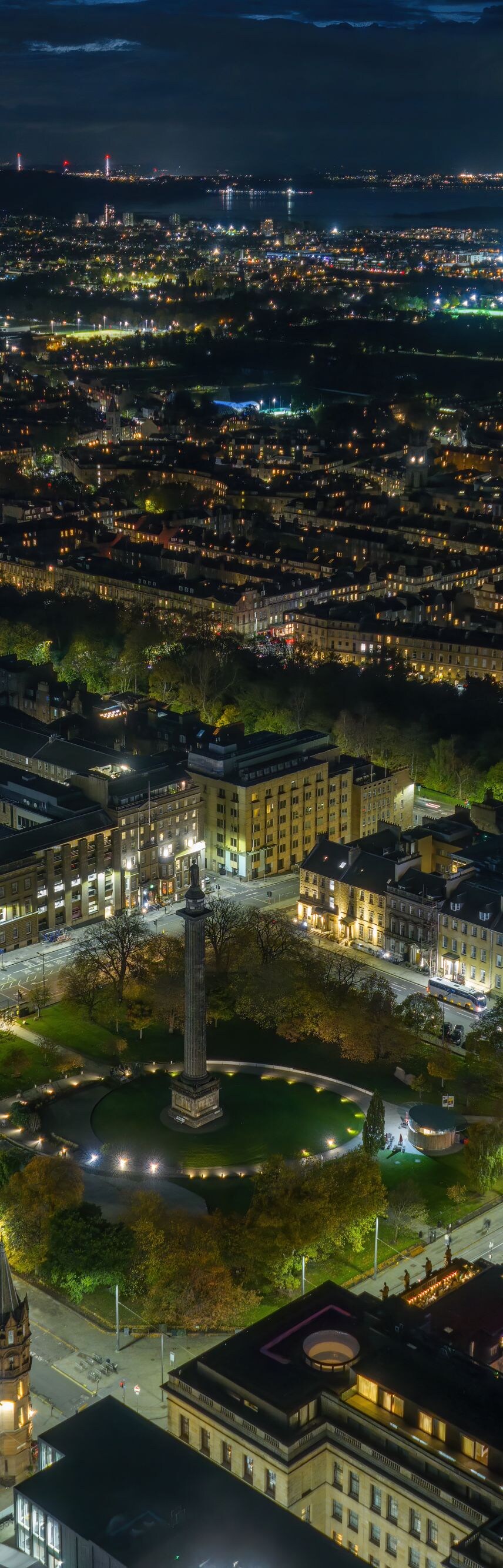 Aerial night view of city lights and buildings