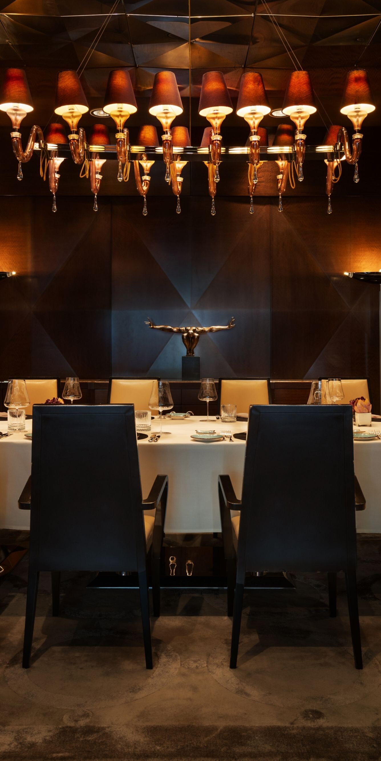 Private dining table beneath statement lighting