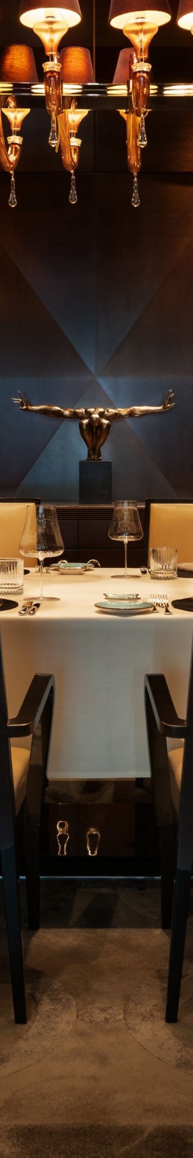 Private dining table beneath statement lighting