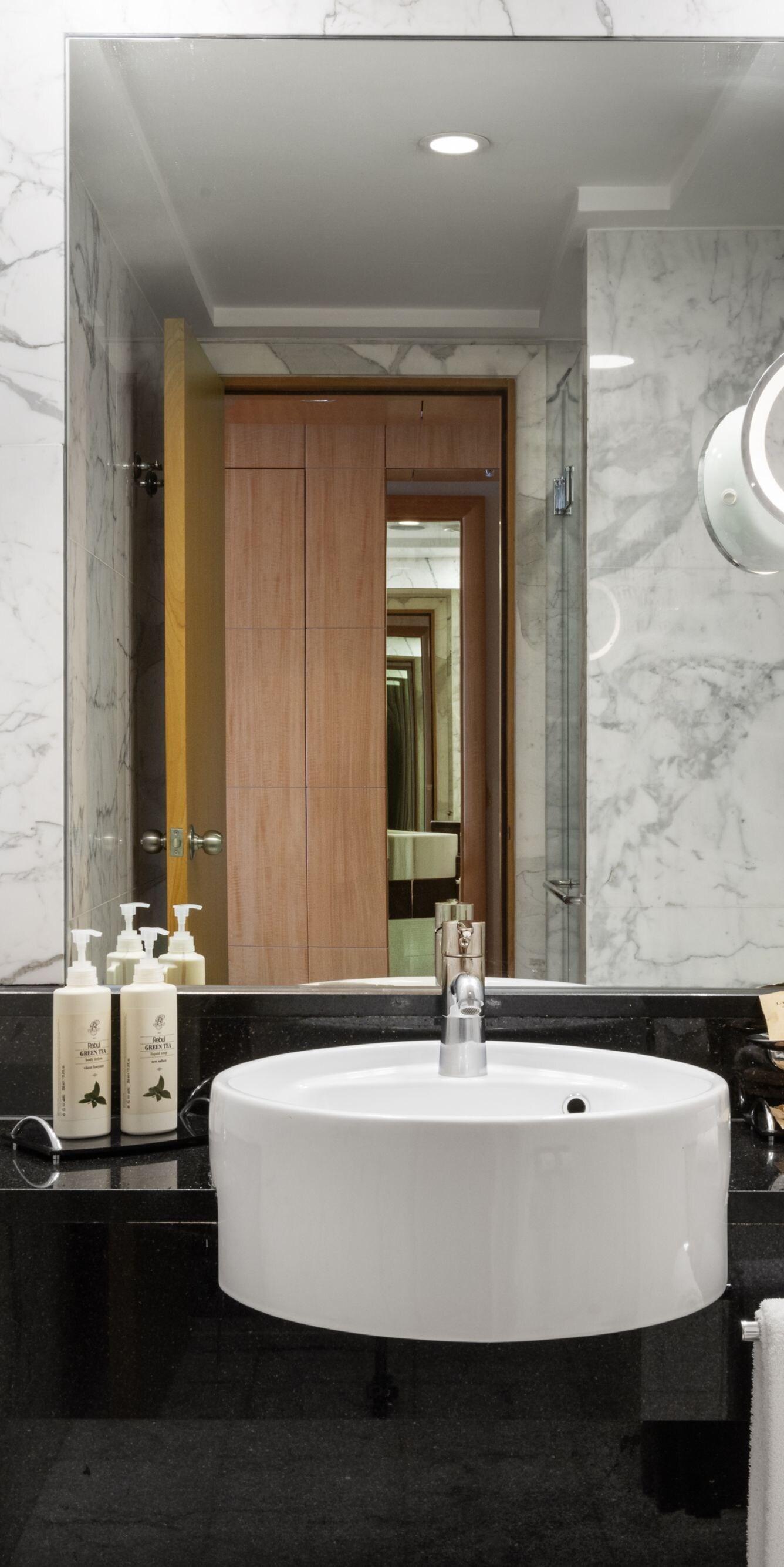 Marble bathroom vanity with illuminated mirror