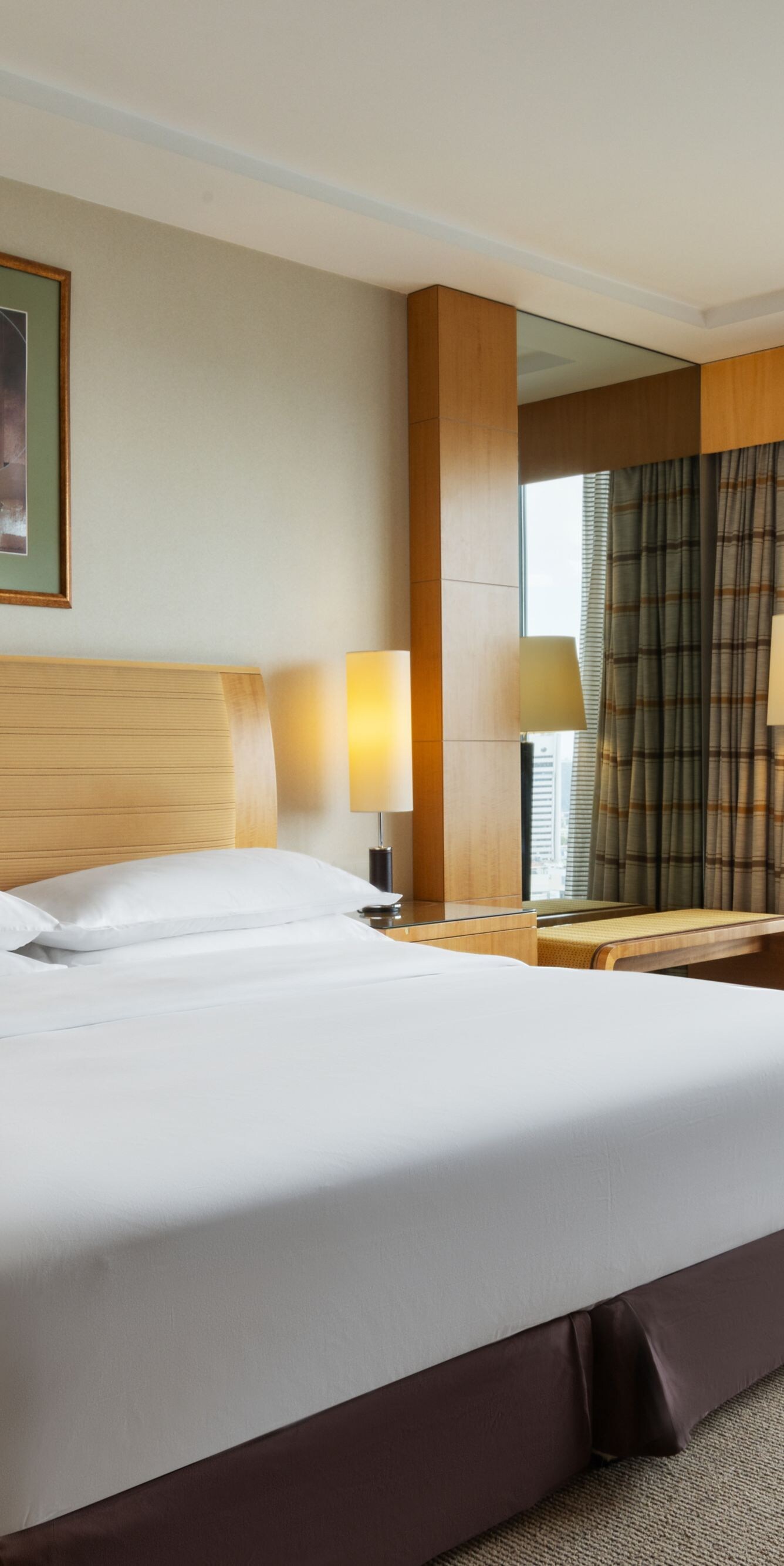 King bed with seating area and city view