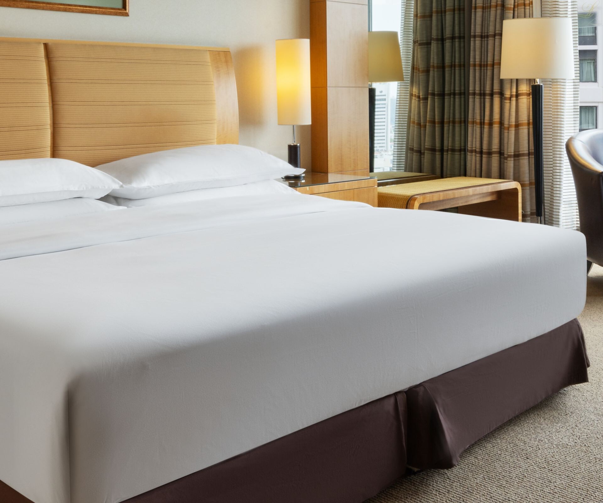King bed with seating area and city view