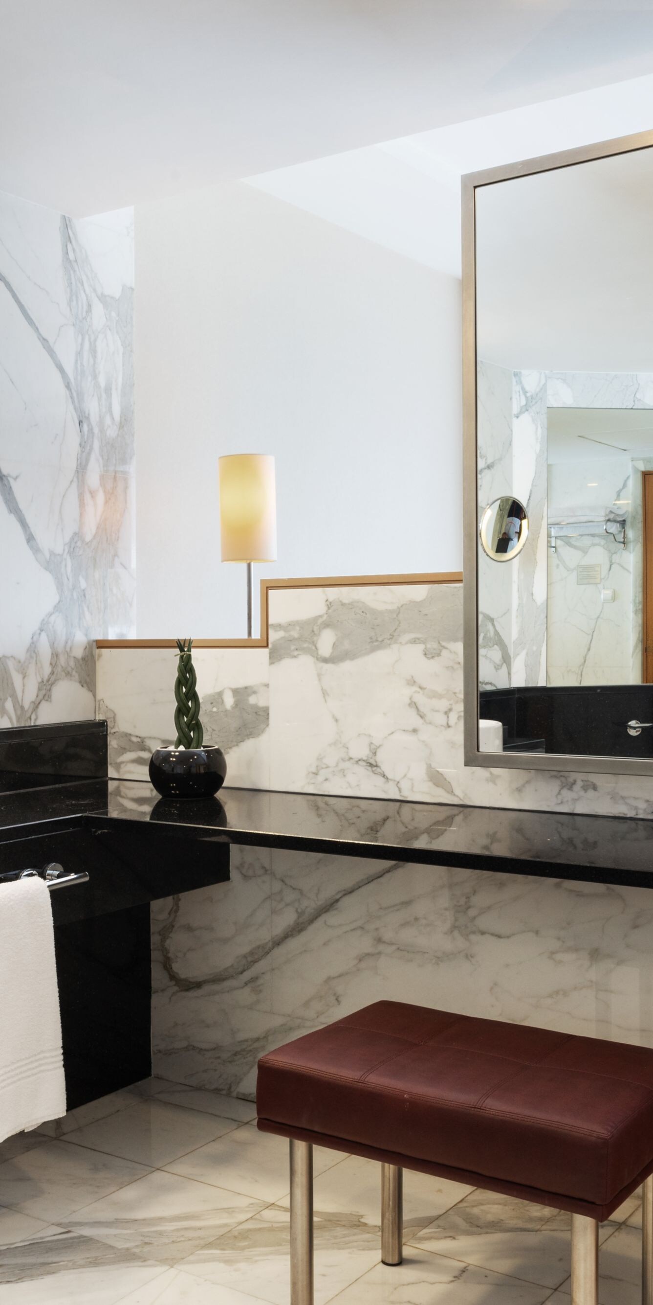 Marble bathroom with vanity and large mirrors
