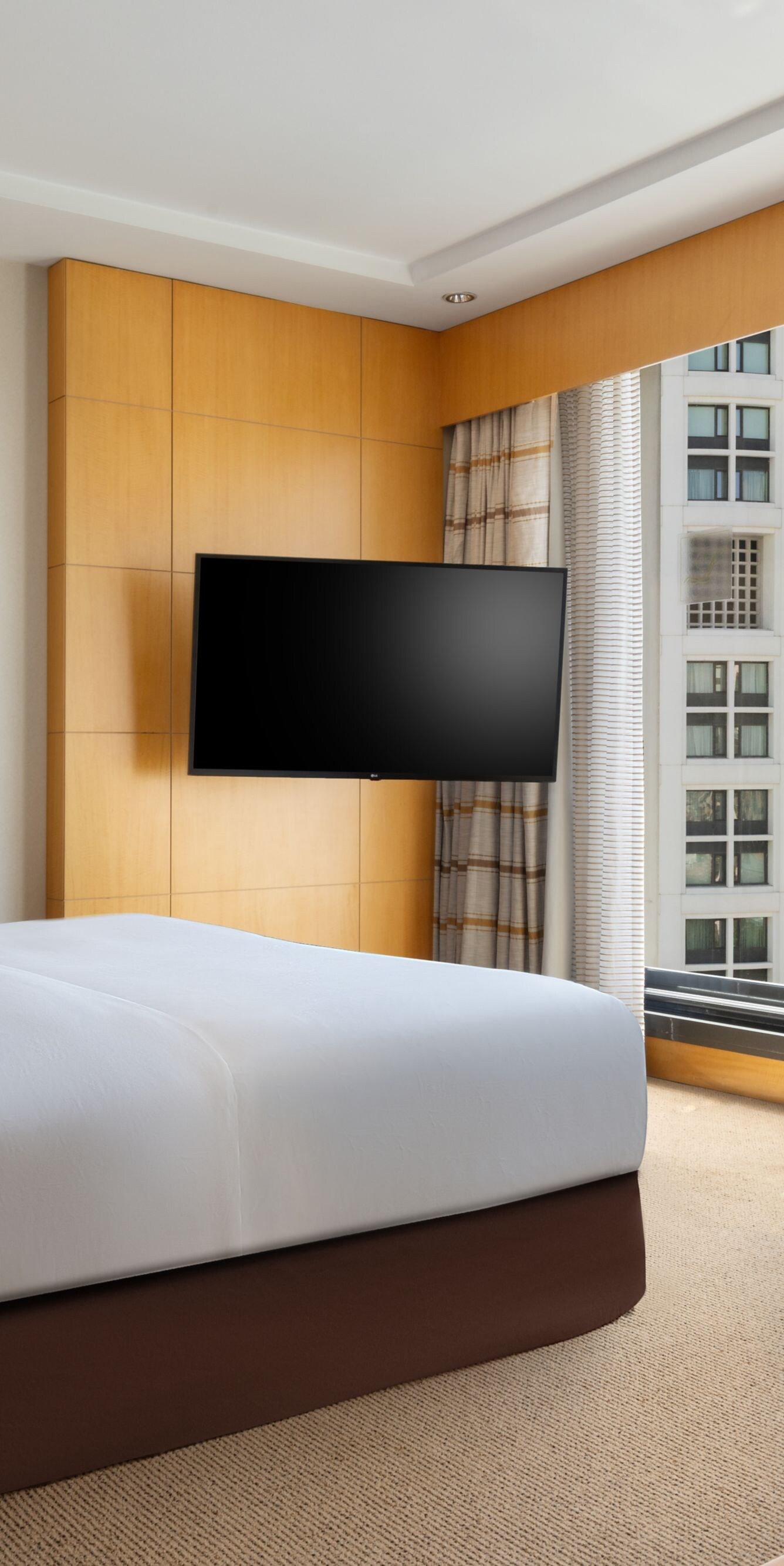 Bedroom with king bed and panoramic city view