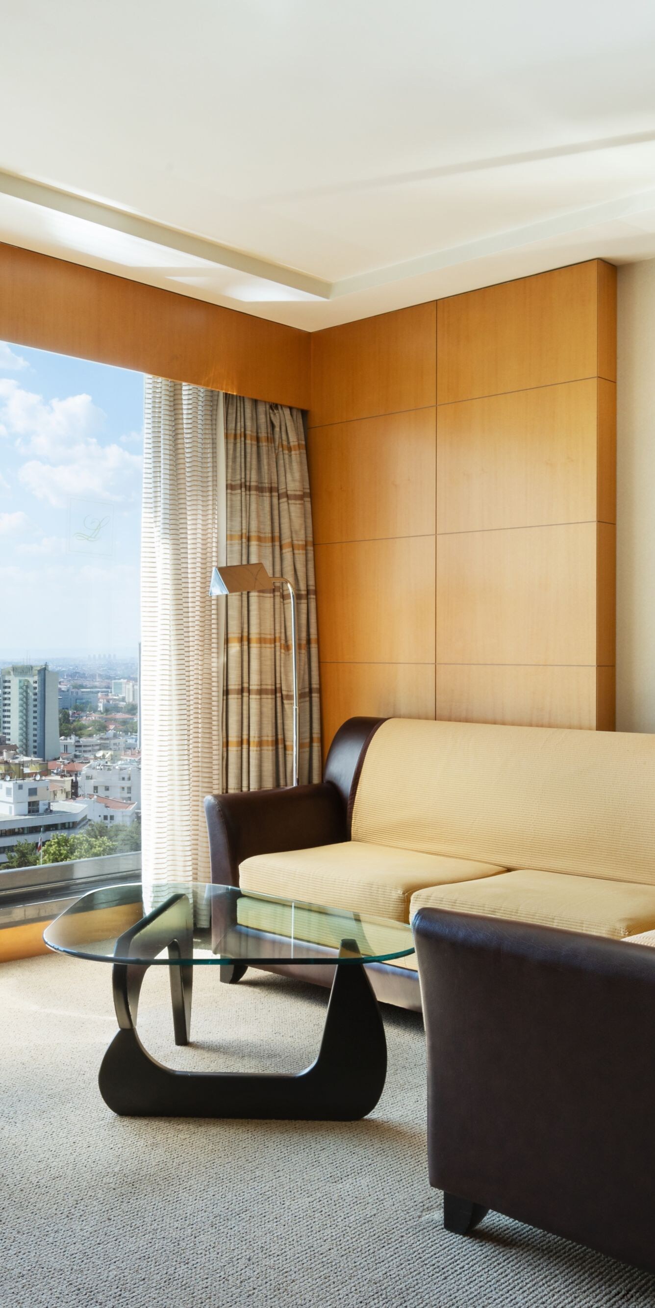 Living room with seating and panoramic city view