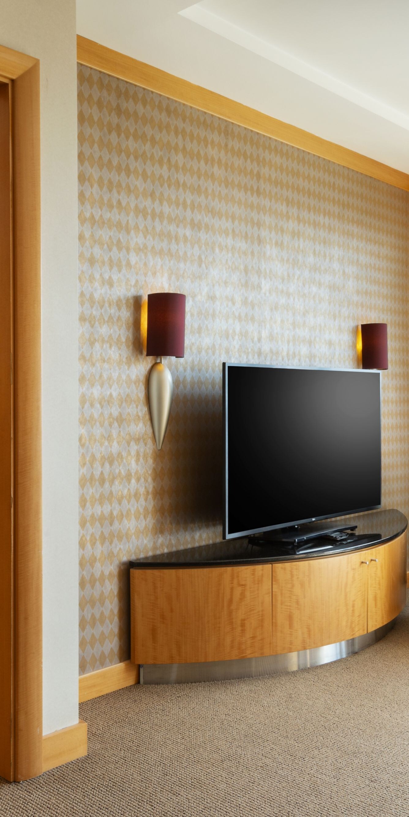 Living room with seating, television and city view