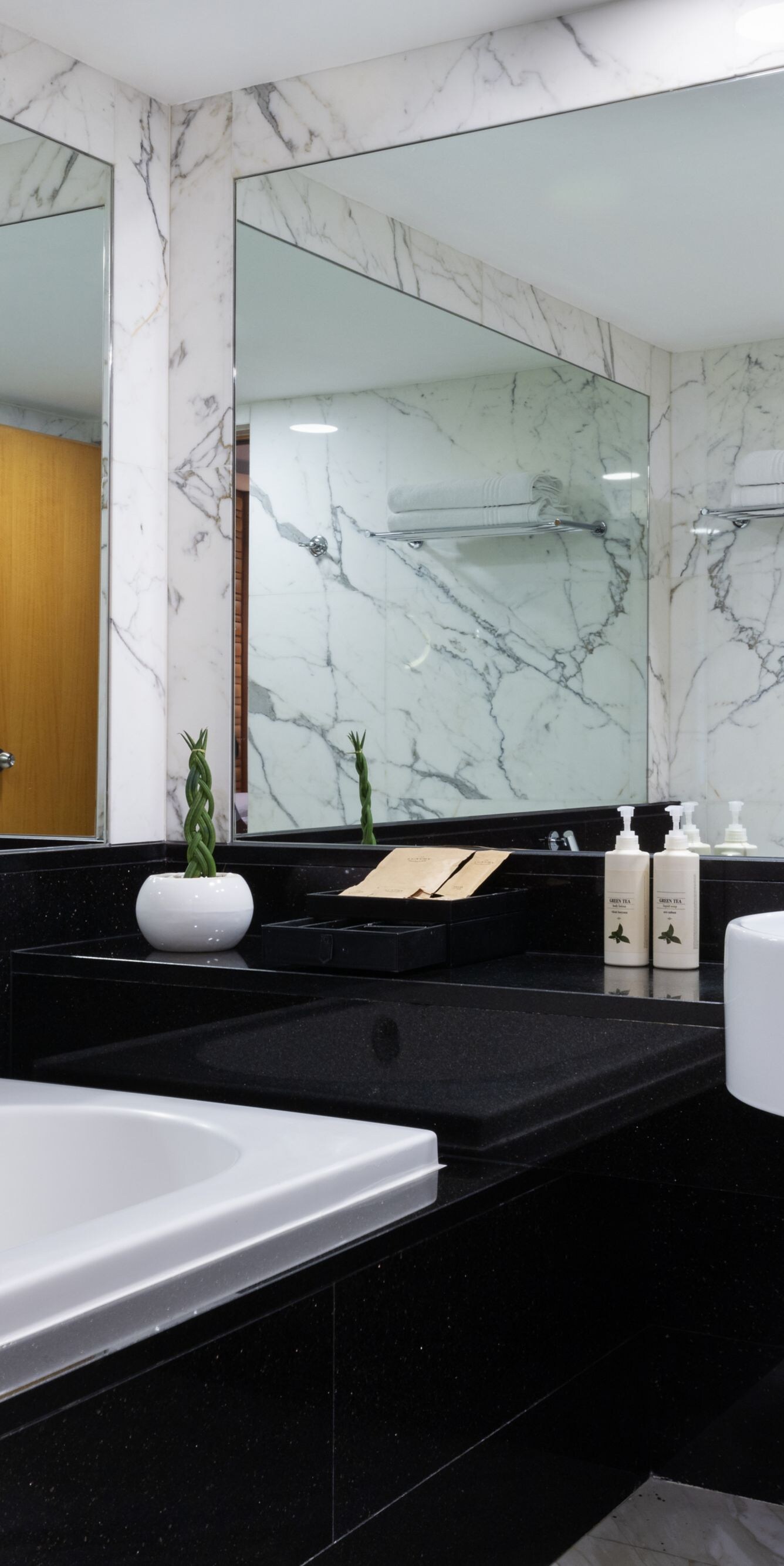 Marble bathroom with bathtub and vanity