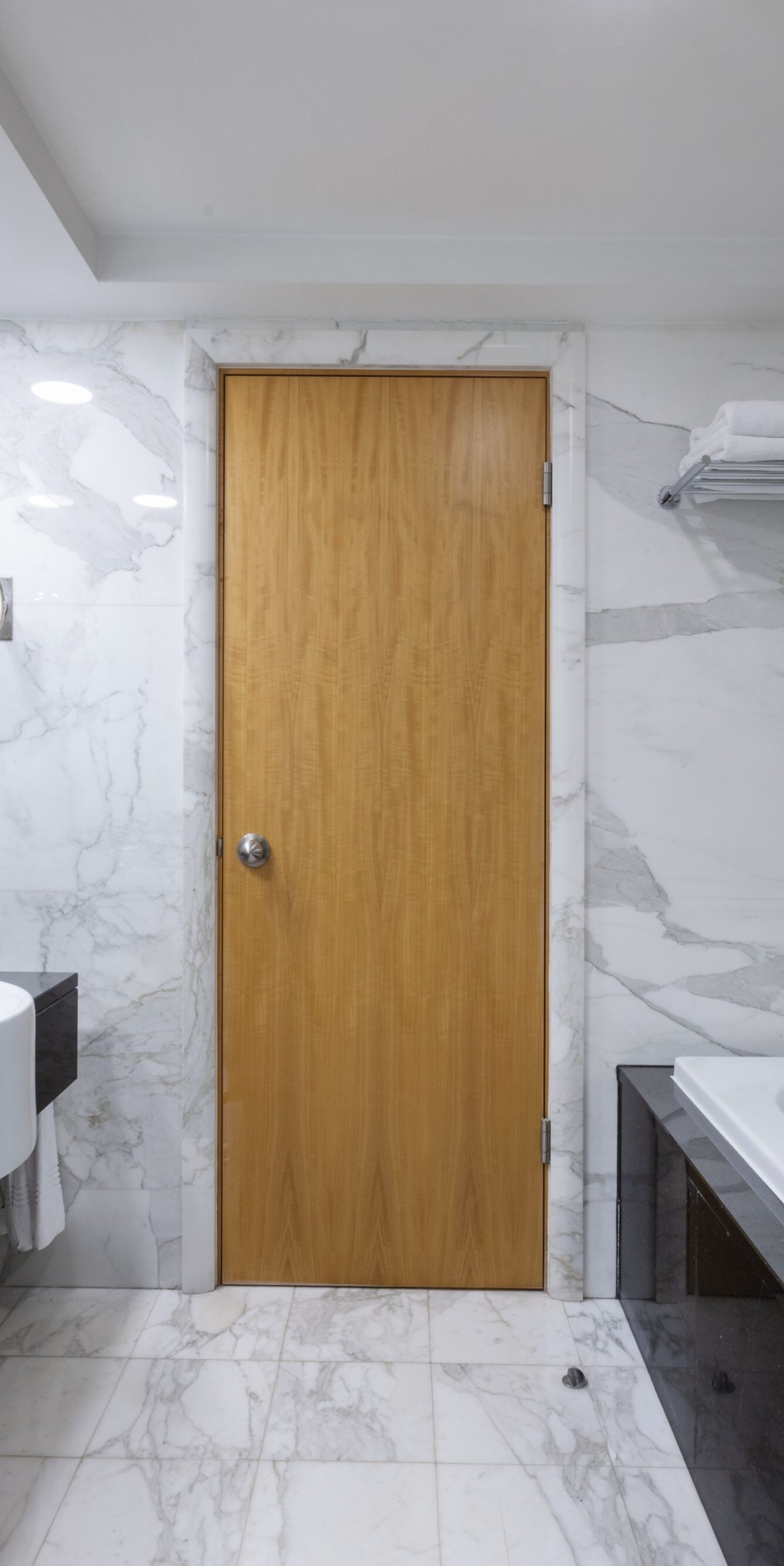 Marble bathroom with bathtub and large mirror