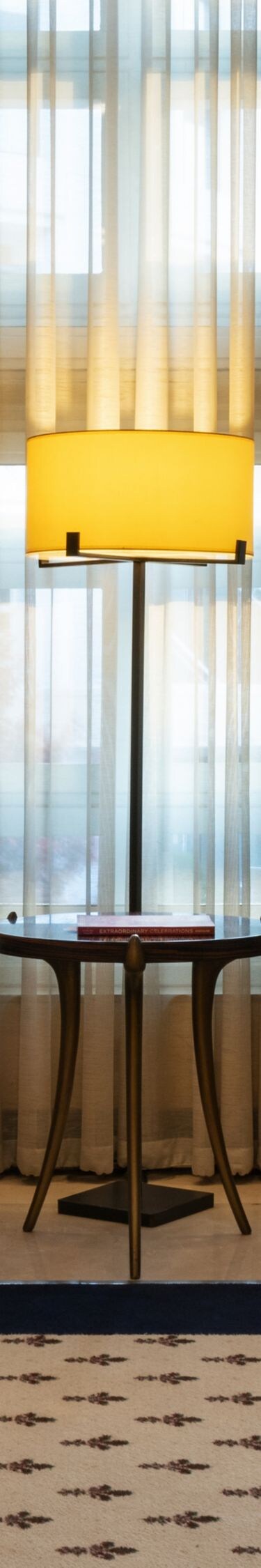 Two high-back chairs beside lobby windows