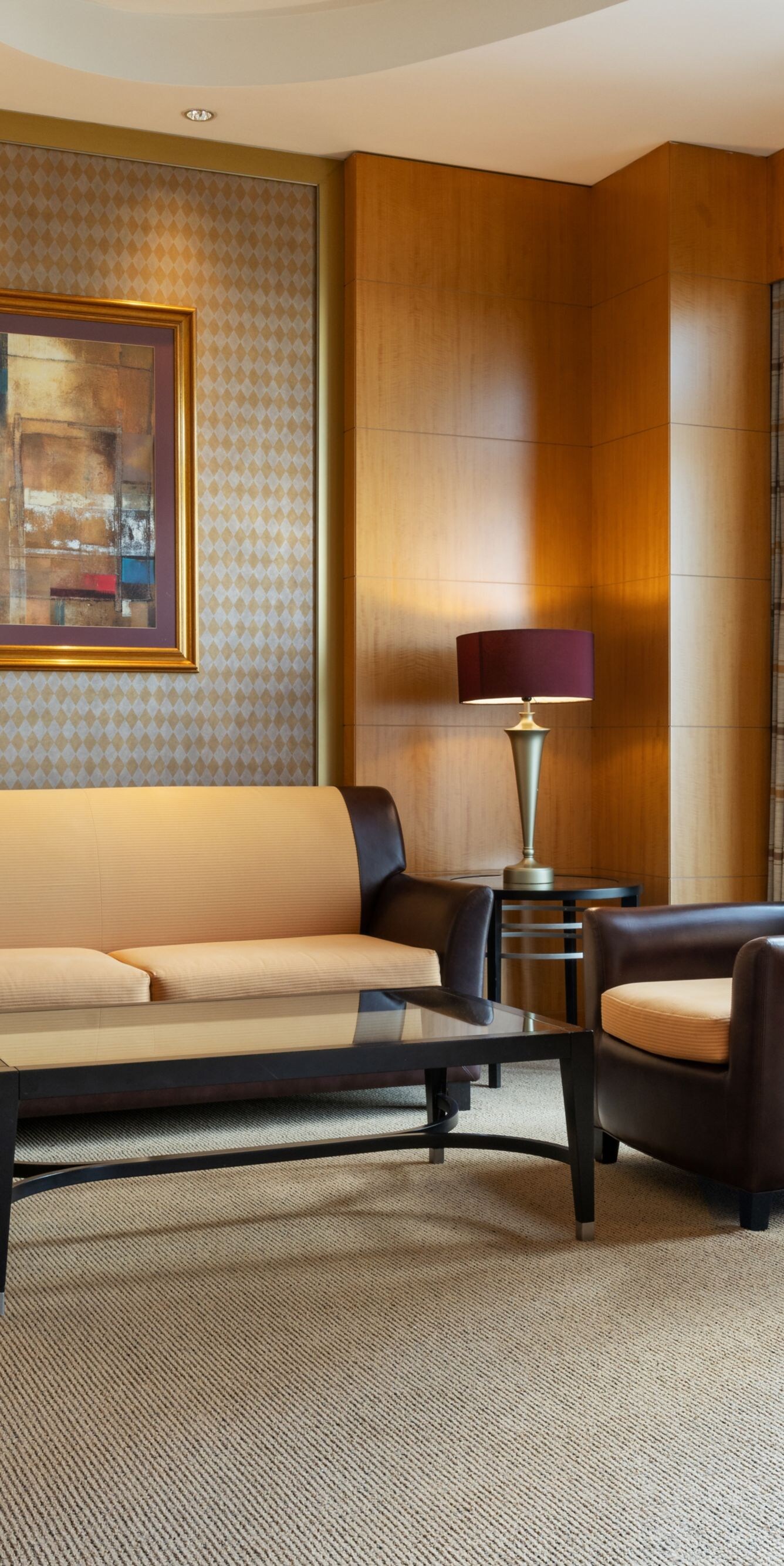 Living room with sofa, armchairs and city view