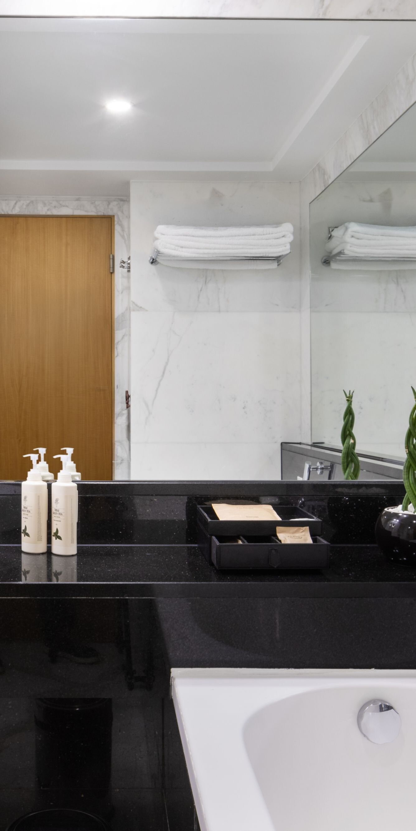 Marble bathroom with bathtub and vanity