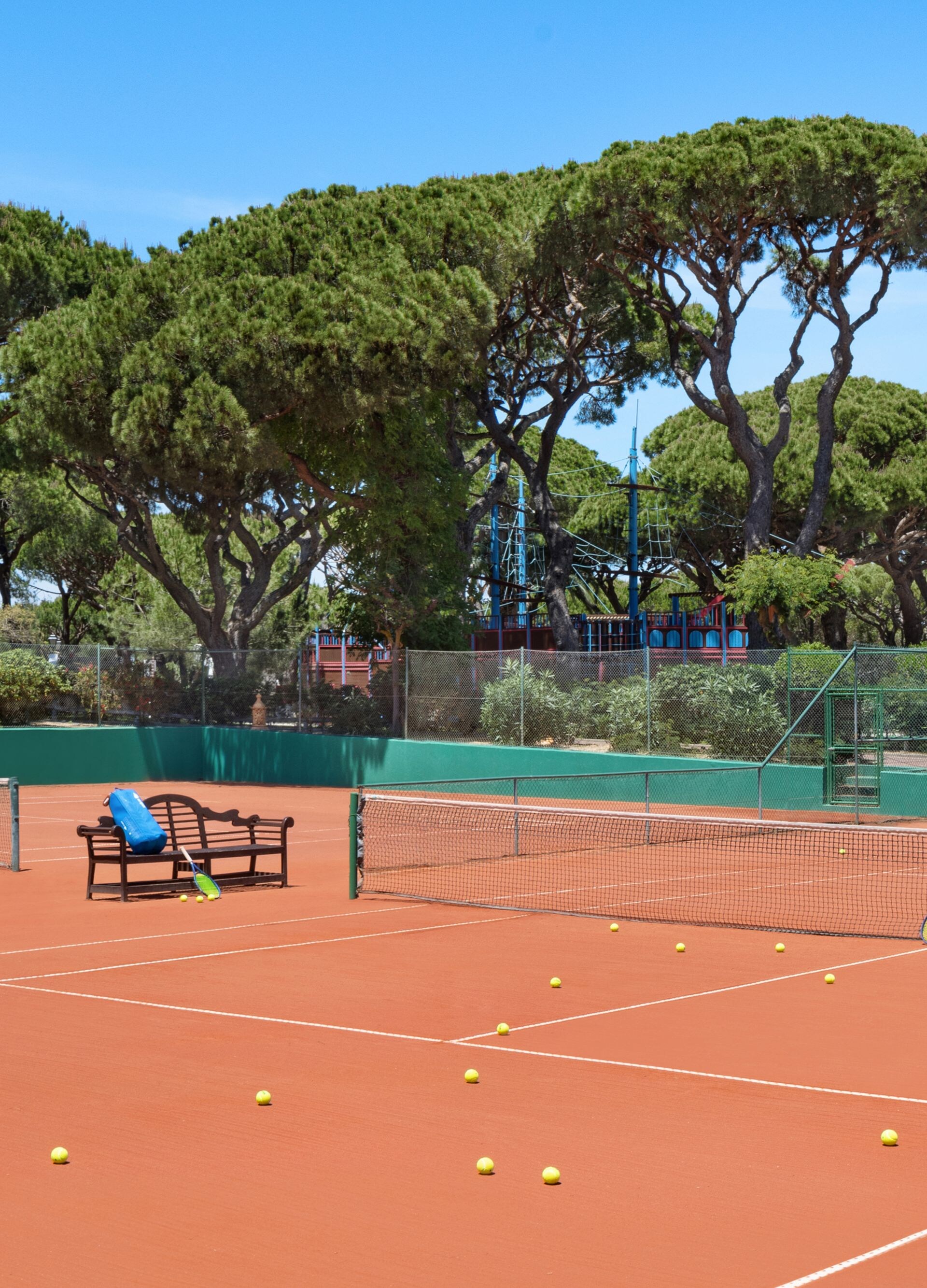 Tennis court with pine trees at Pine Cliffs