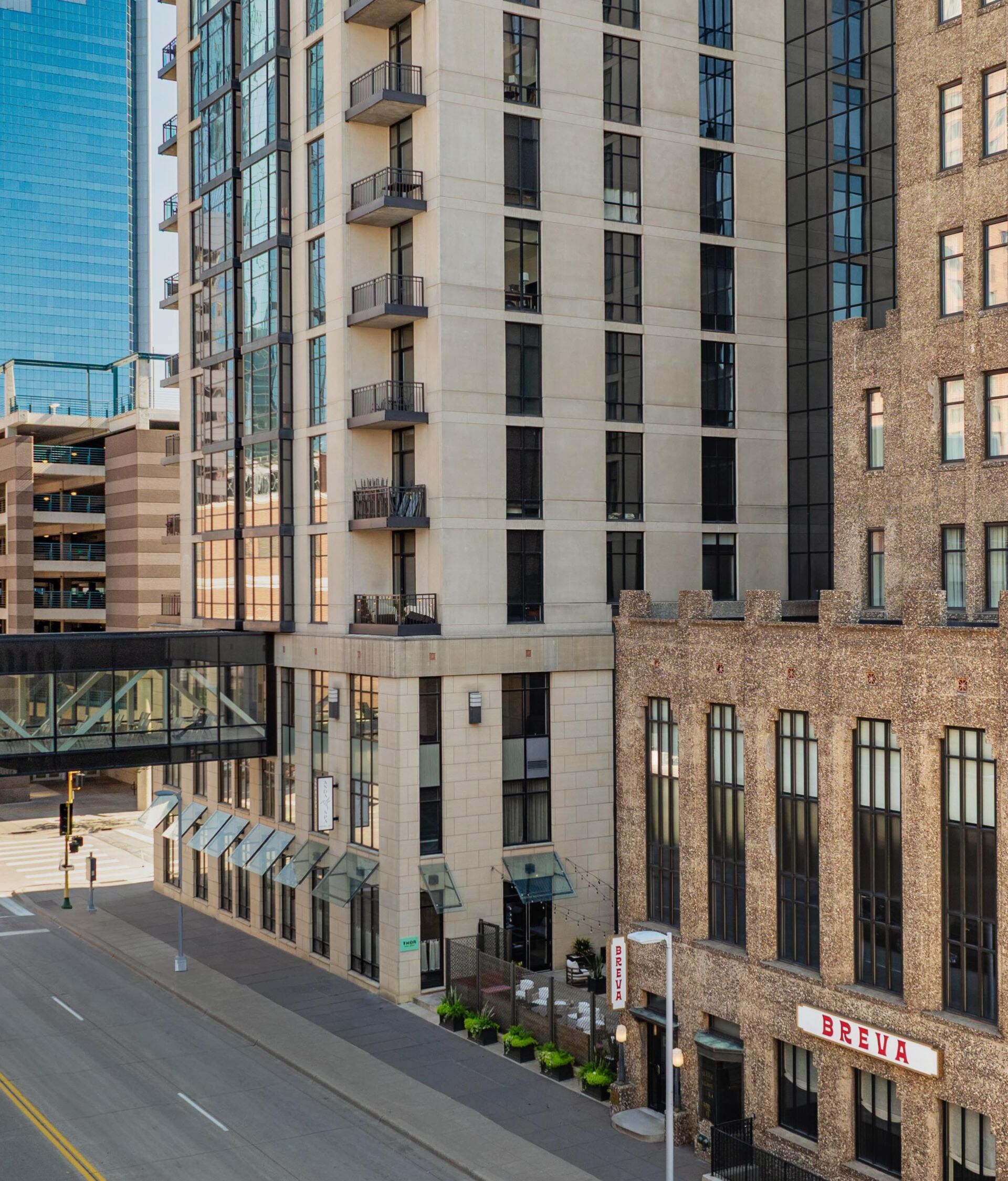 exterior of hotel with sky bridge conneting two bu