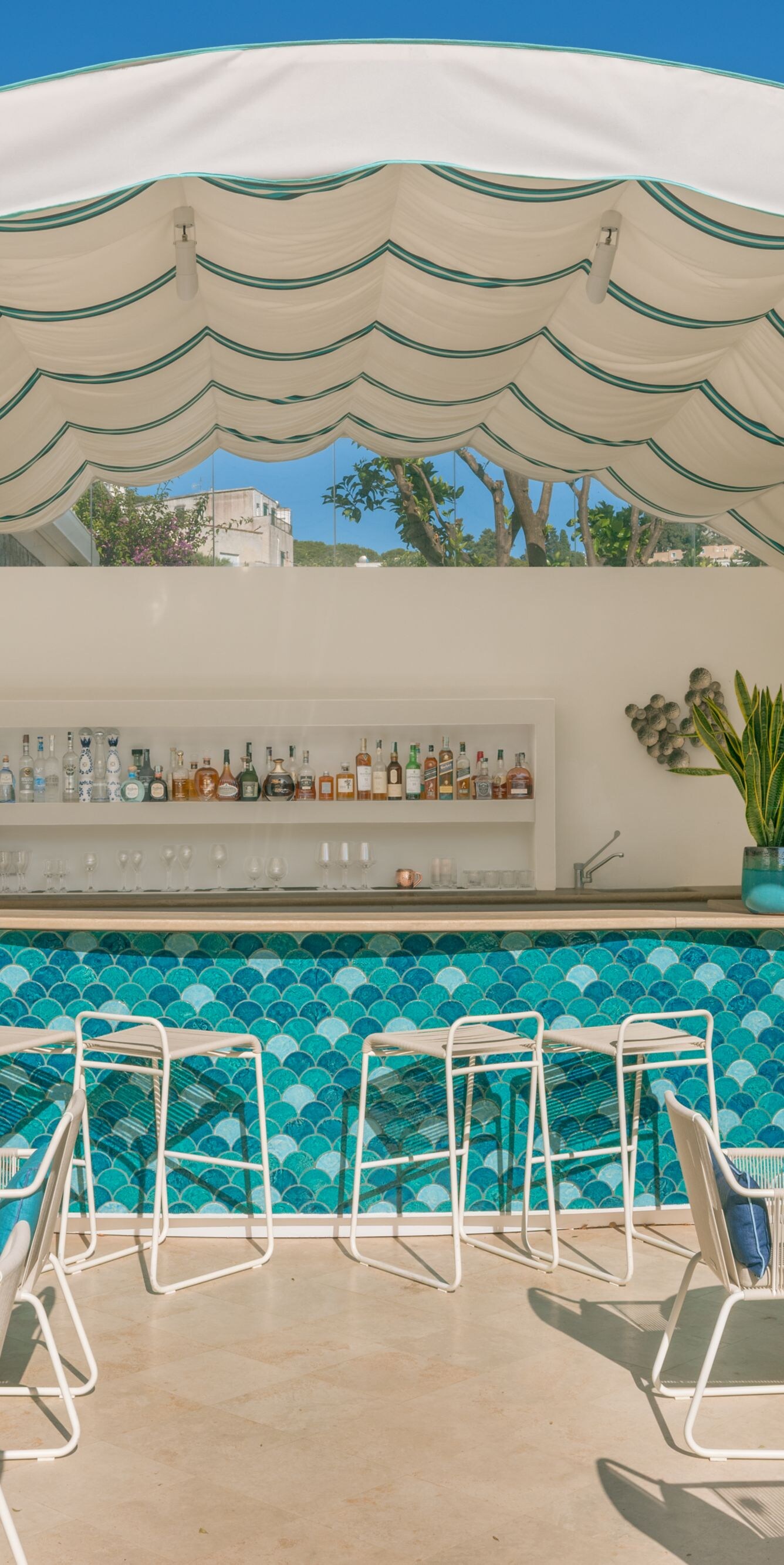 Outdoor poolside bar with shaded seating area.