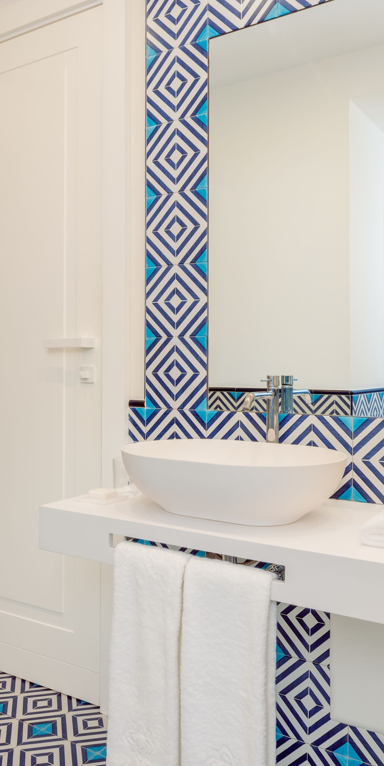 Modern bathroom with double sinks and tiled shower