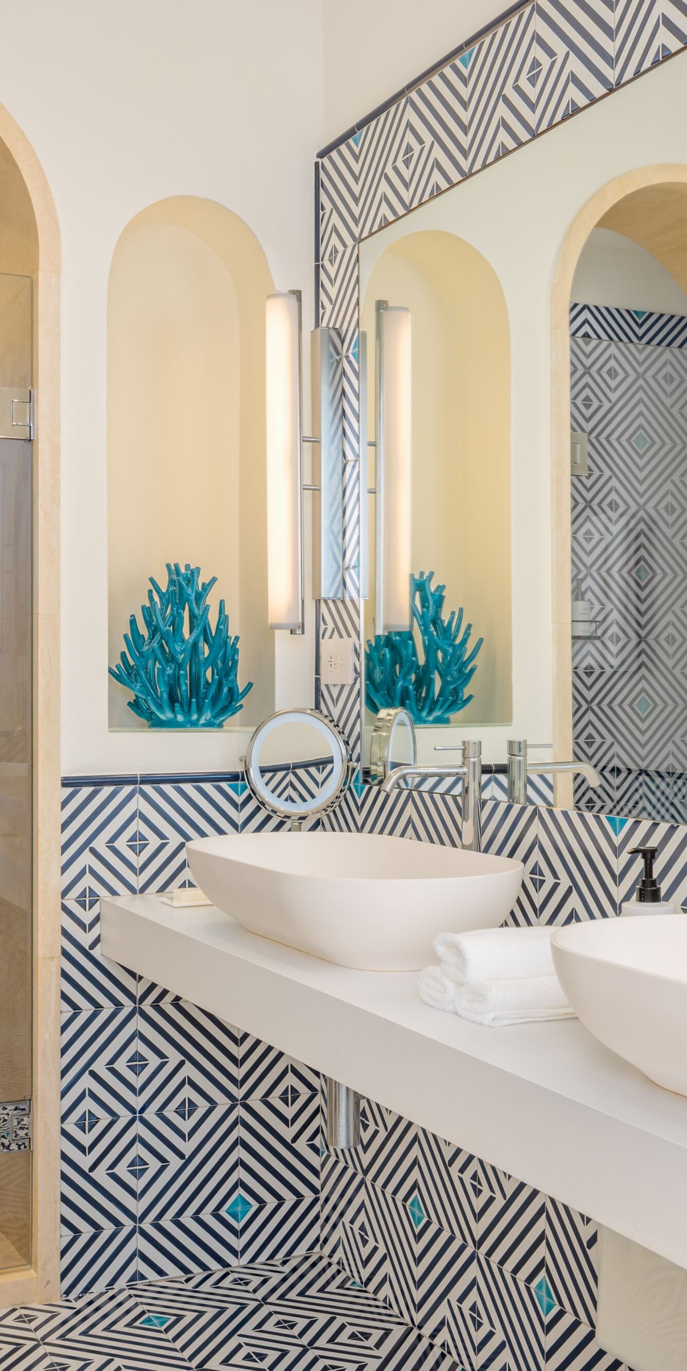Modern bathroom with double sinks and tiled shower