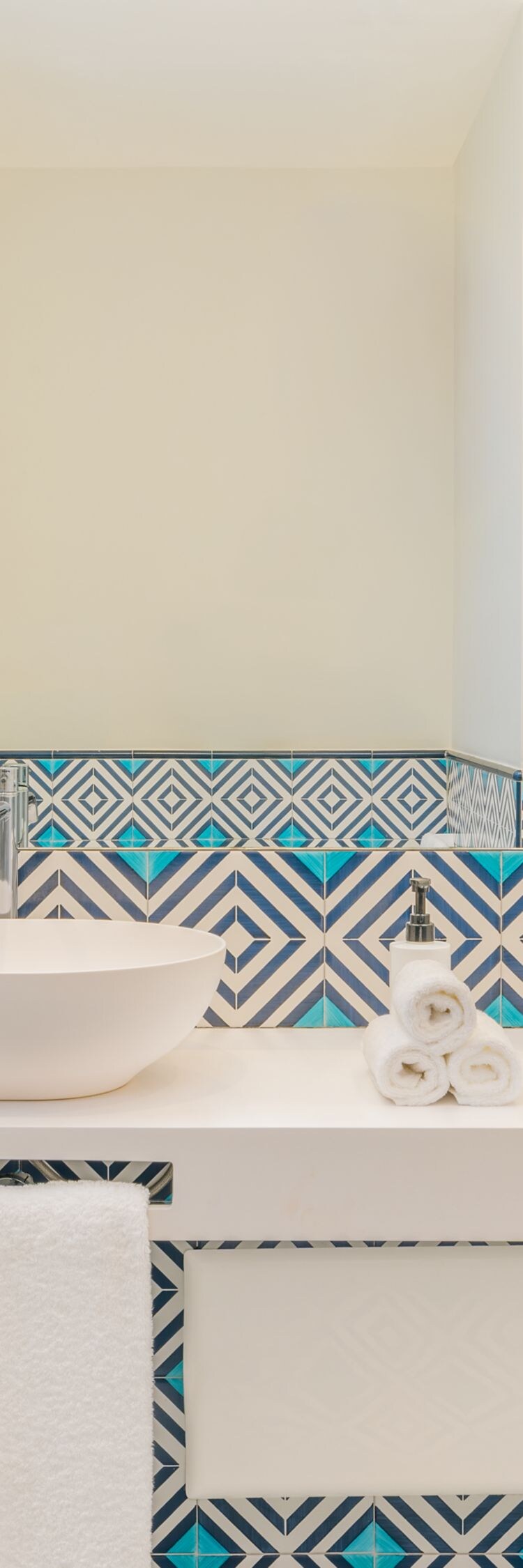 bathroom with dual sinks and patterned tiles