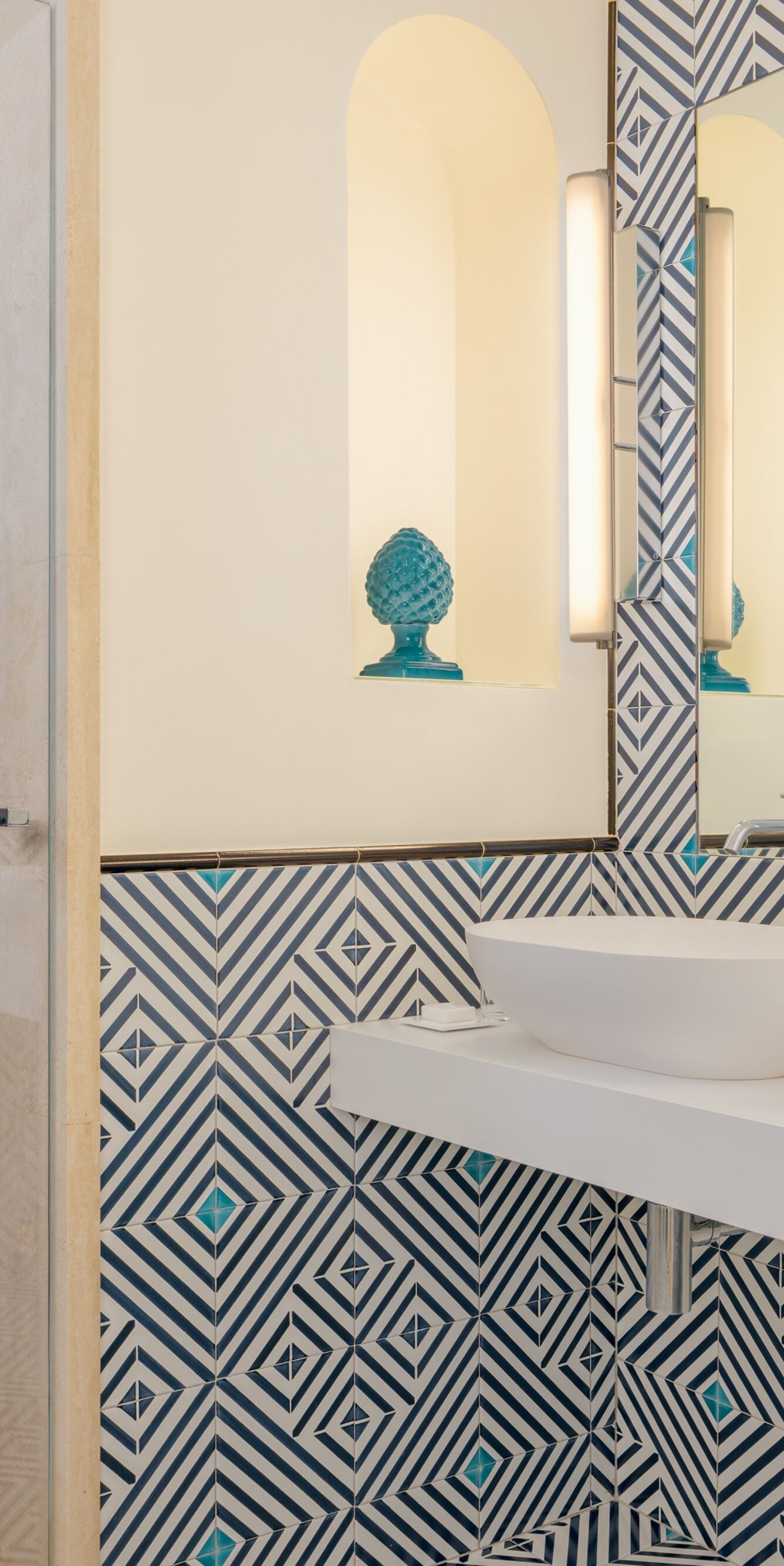 bathroom with dual vanities and walk-in shower