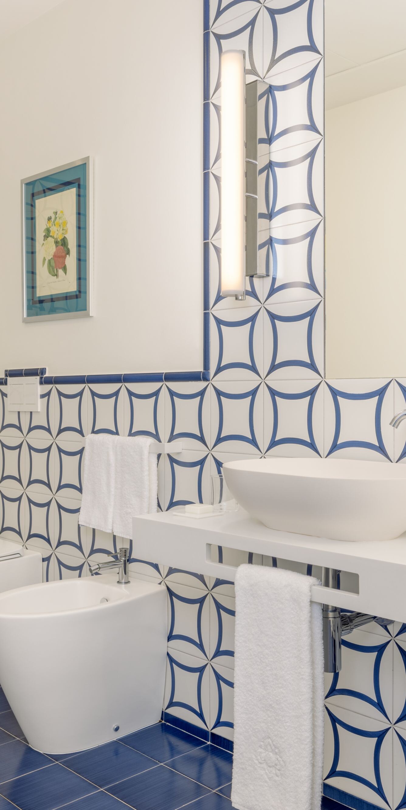 Blue and white tiled bathroom with double vanity