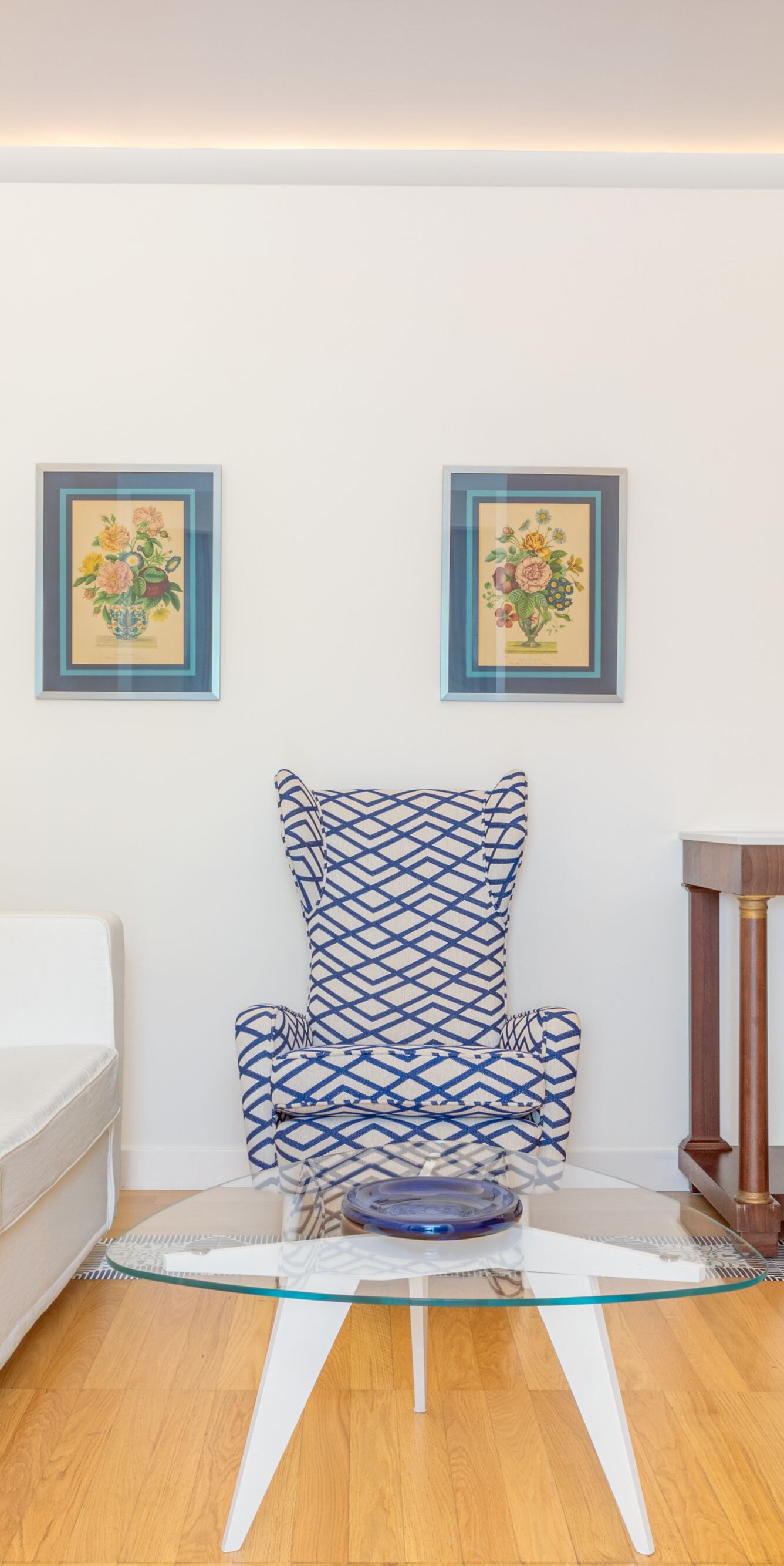 Bright living area with sofa, chair and table