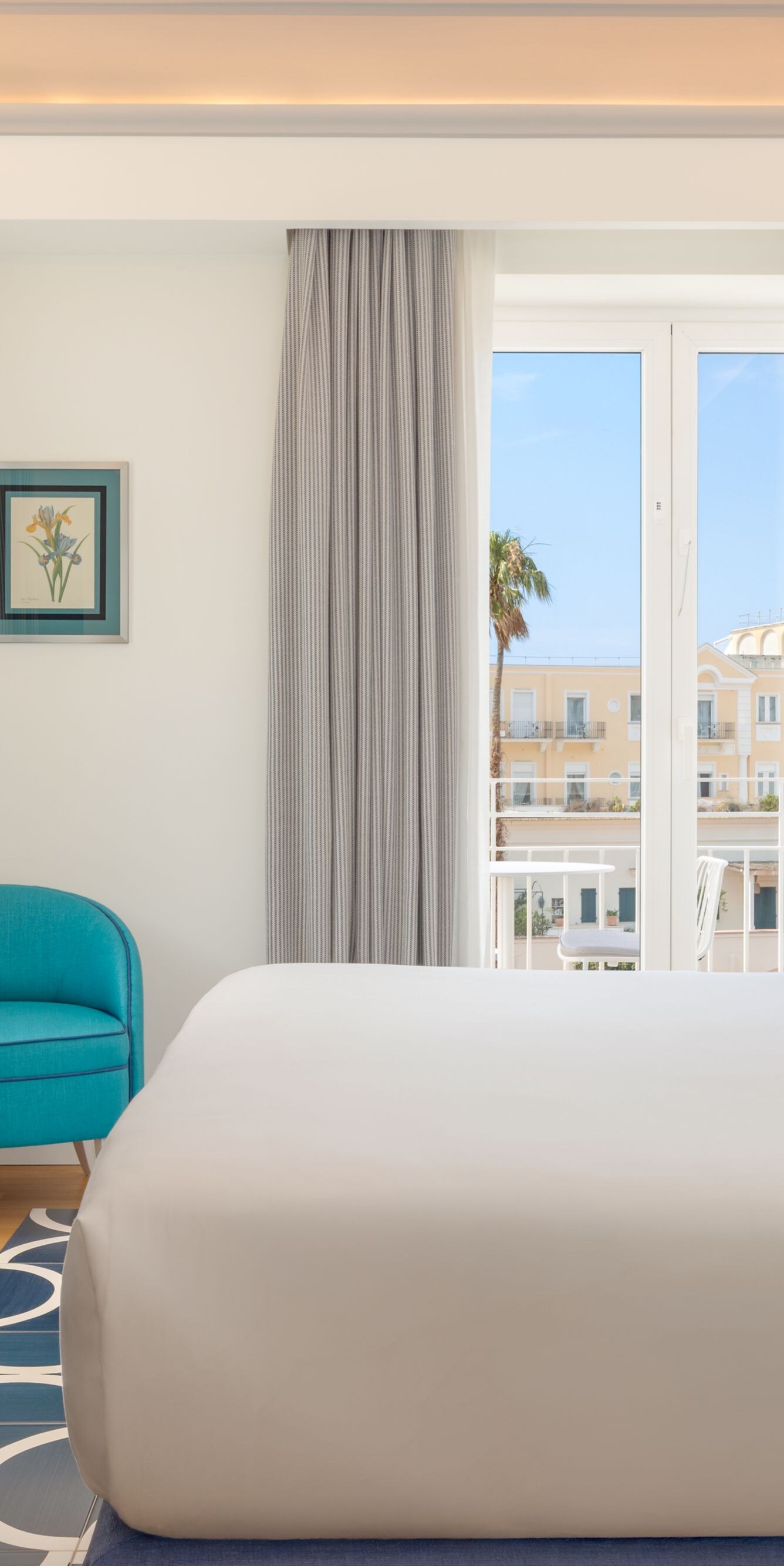 Bright guest room with king bed and balcony view