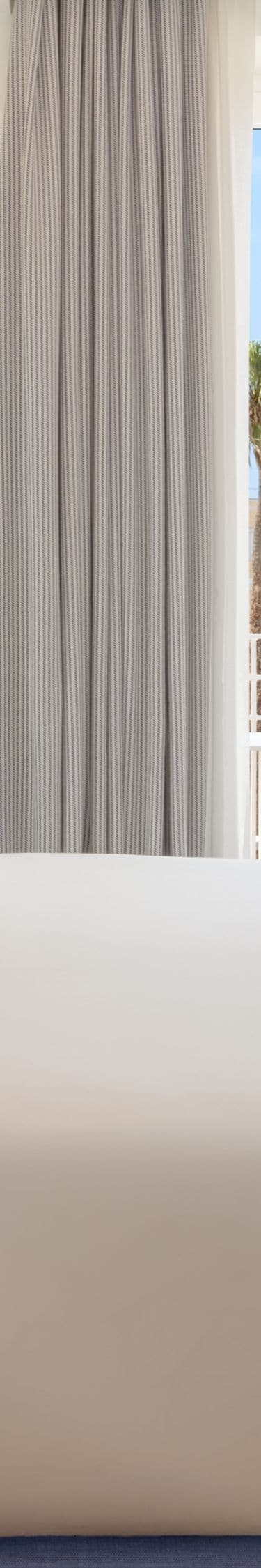 Bright guest room with king bed and balcony view