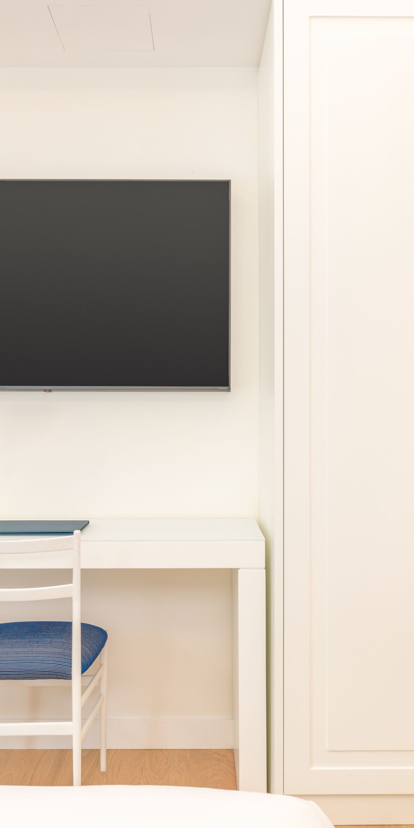 Guest room desk with chair, TV and wardrobe