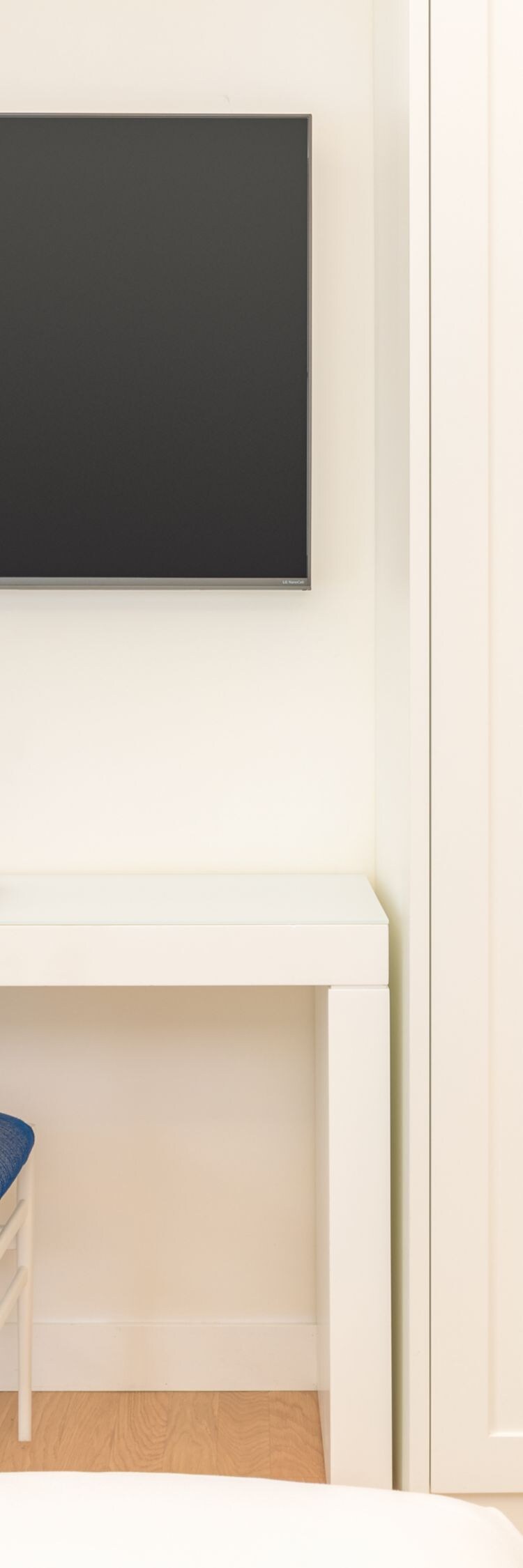 Guest room desk with chair, TV and wardrobe
