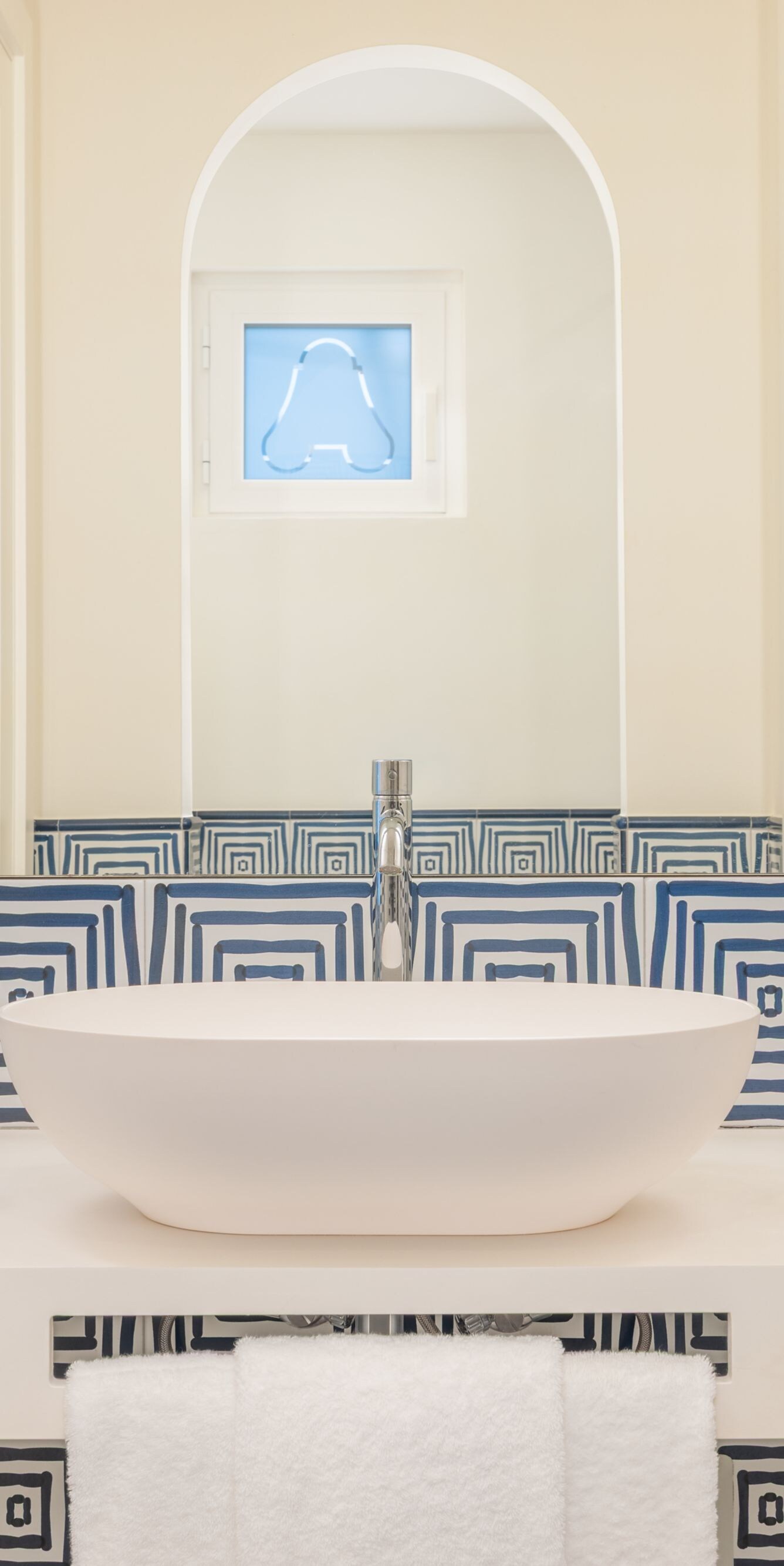 Blue patterned vanity with vessel sink and mirror