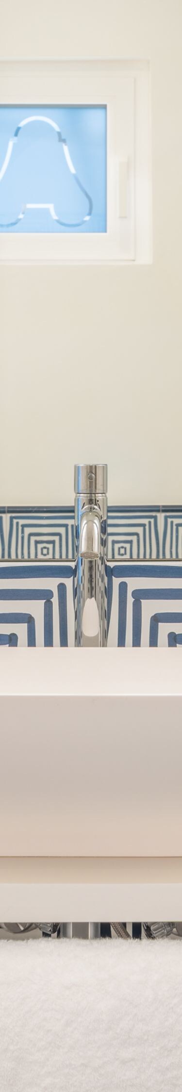 Blue patterned vanity with vessel sink and mirror