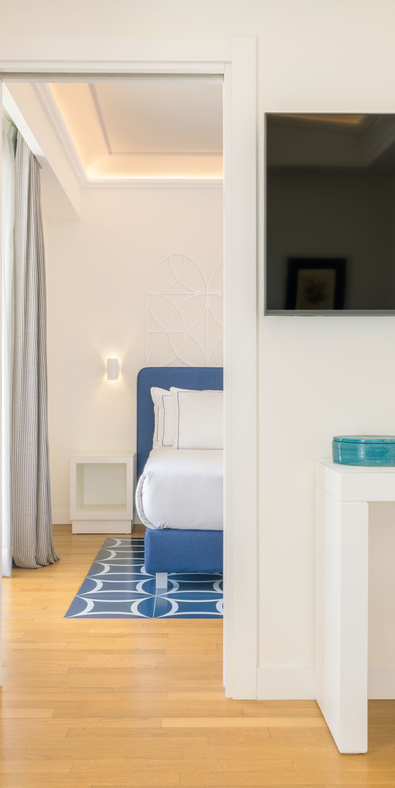 Desk area with TV and view into bedroom suite