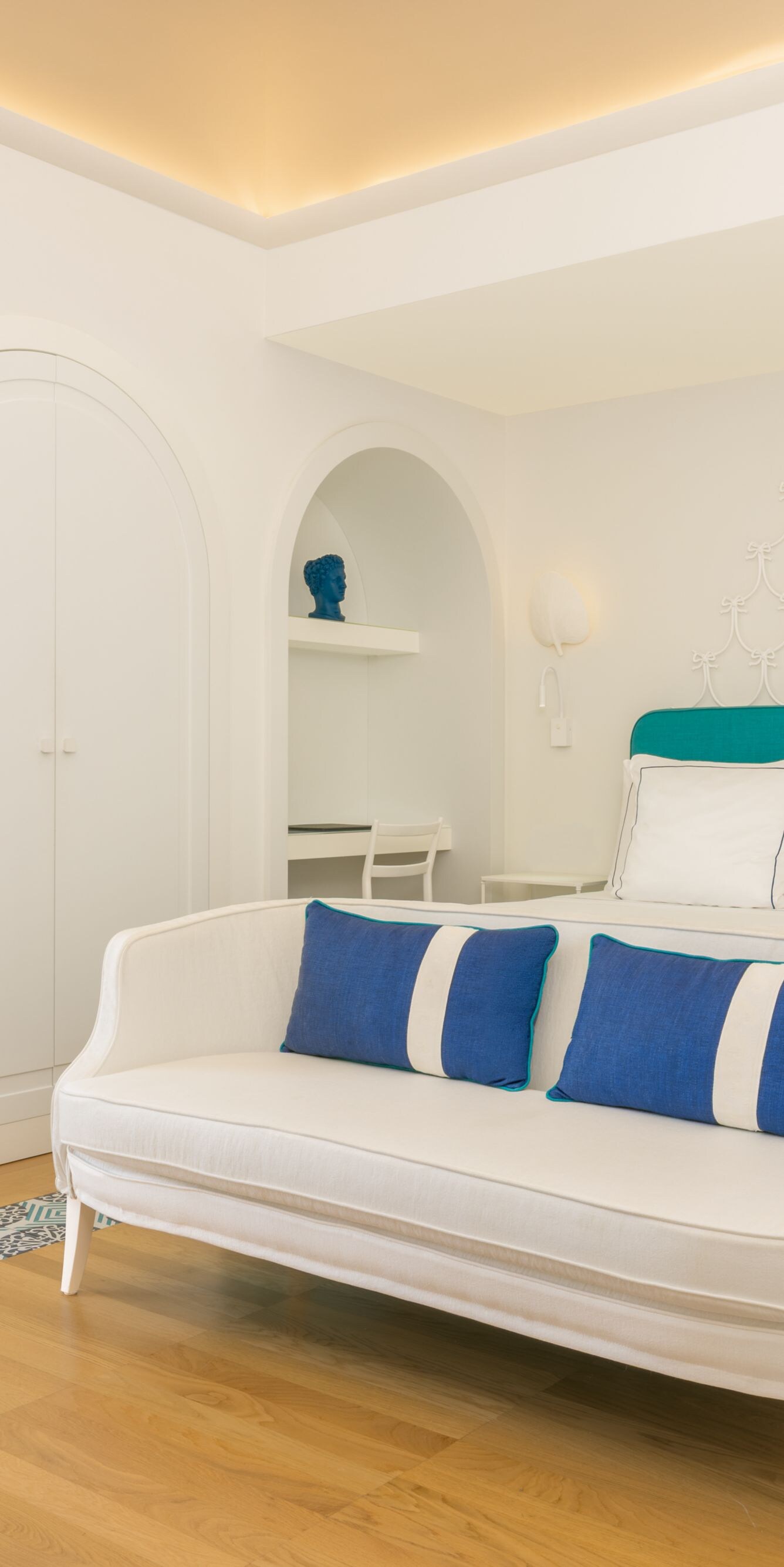Bright guest room with sofa seating and king bed