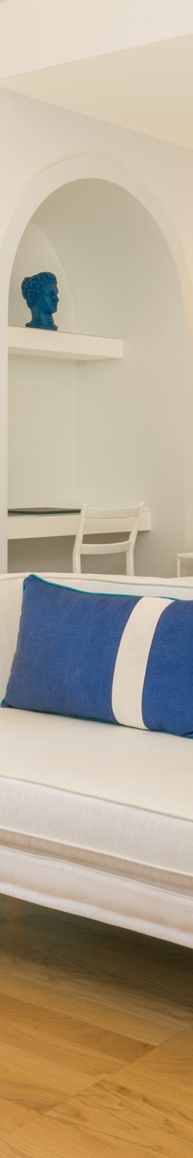 Bright guest room with sofa seating and king bed