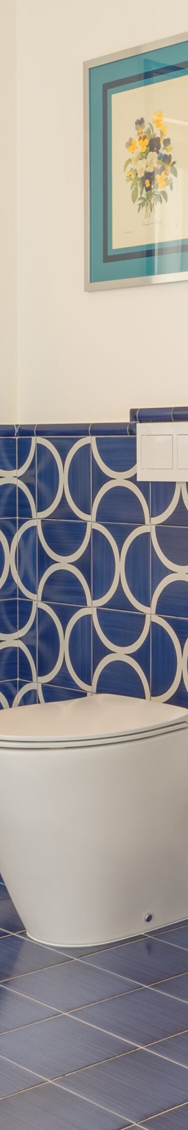 Blue tiled bathroom with walk-in glass shower