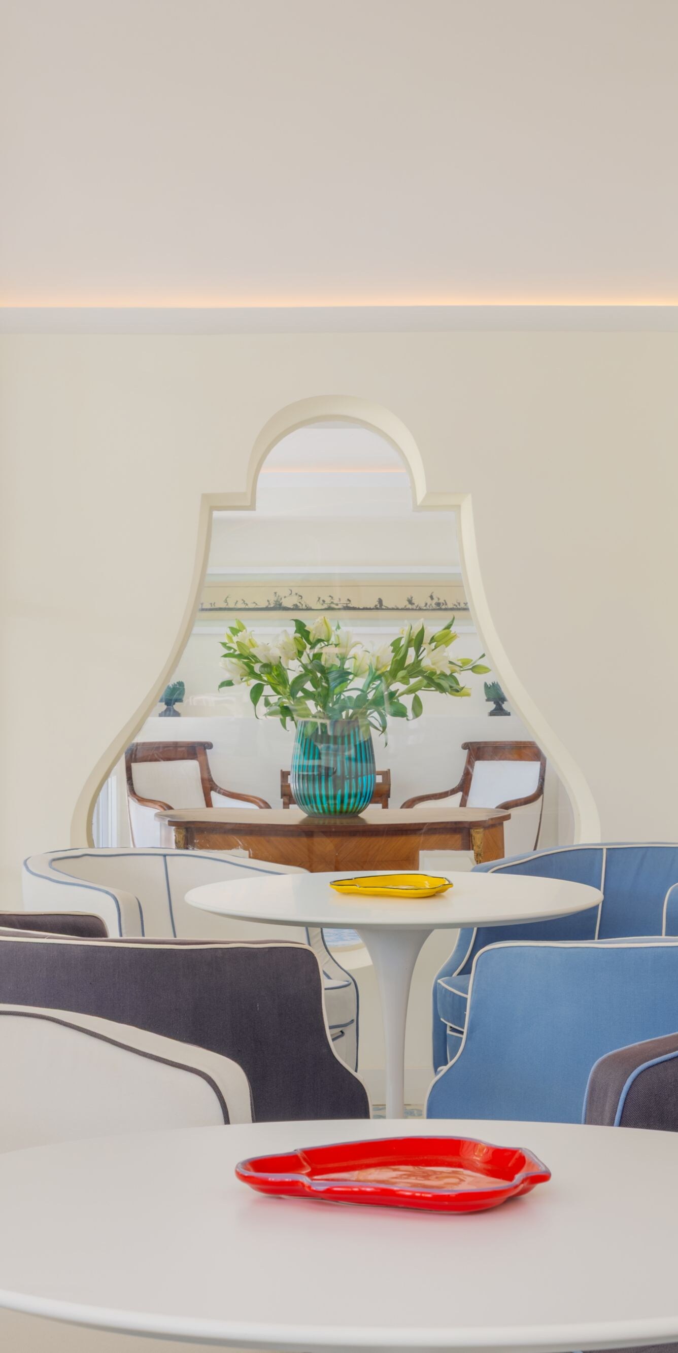 Lobby seating area with tables and garden views