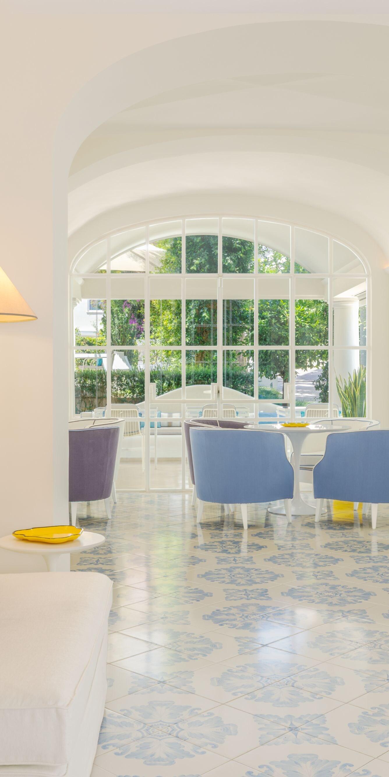 Bright hotel lounge with seating and garden views