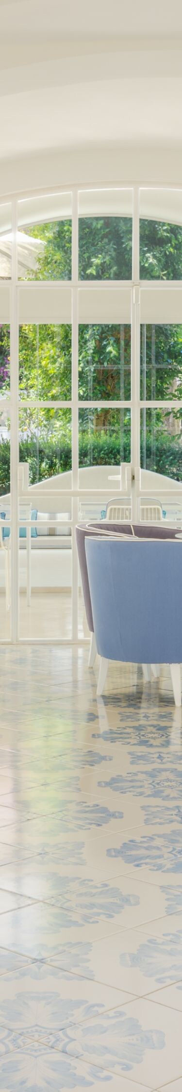 Bright hotel lounge with seating and garden views