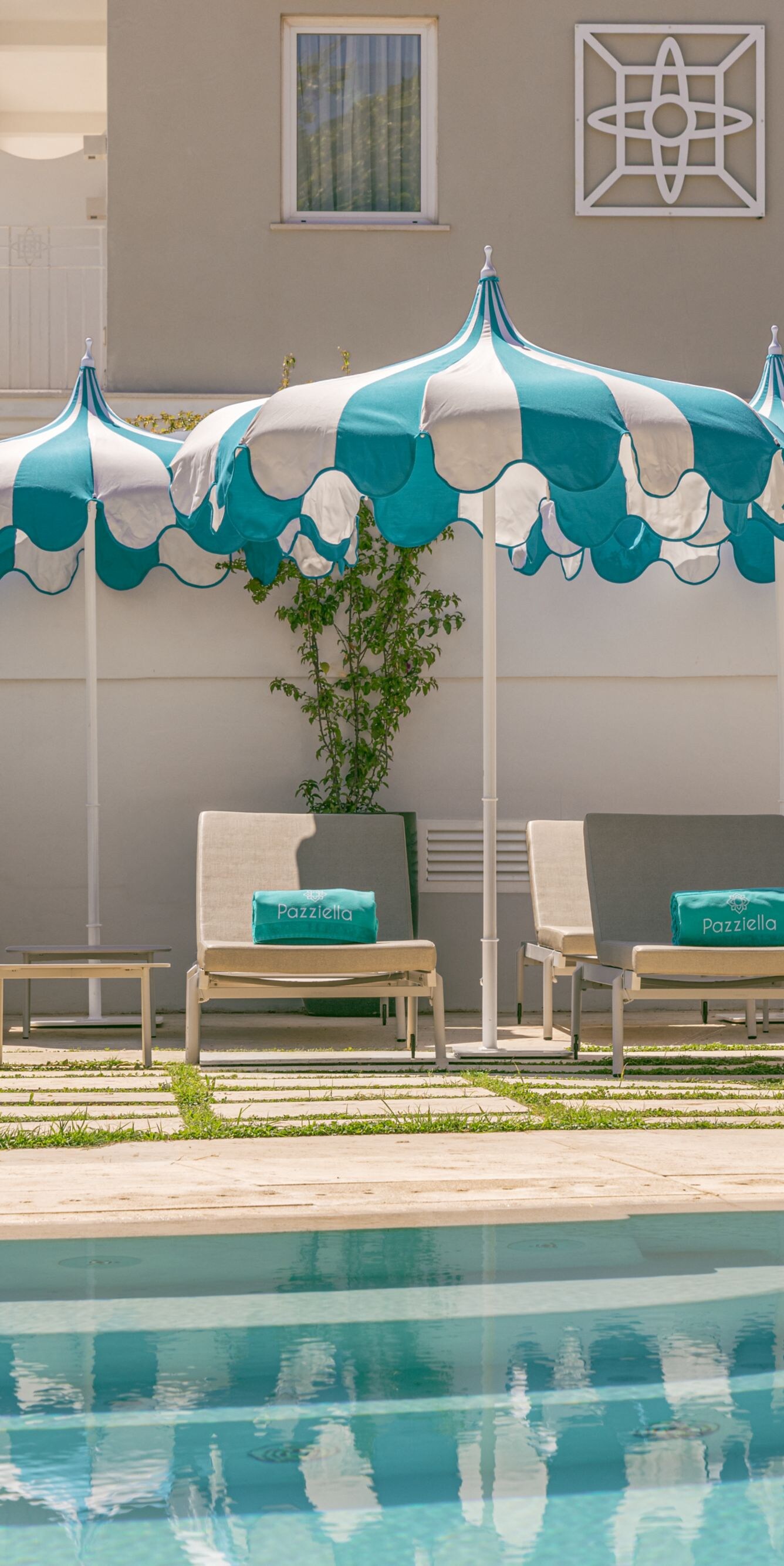 outdoor pool, sun chairs, and umbrellas