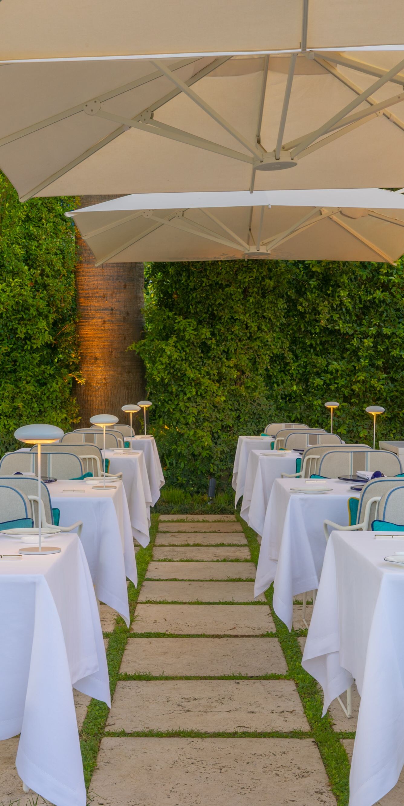 Outdoor dining patio with tables under umbrellas