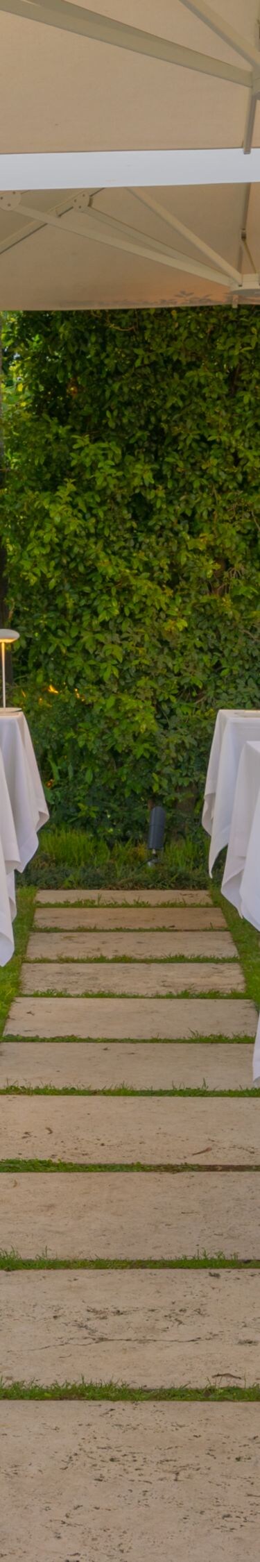 Outdoor dining patio with tables under umbrellas