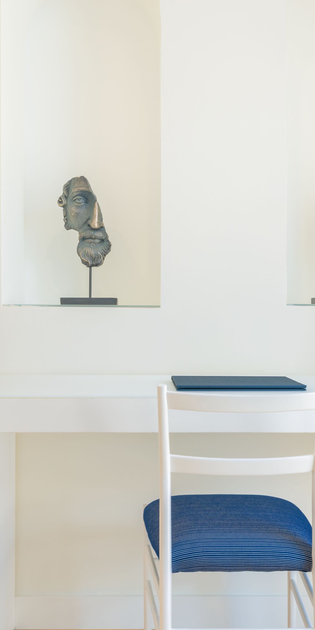 In-room desk with chair, water carafe, and decor