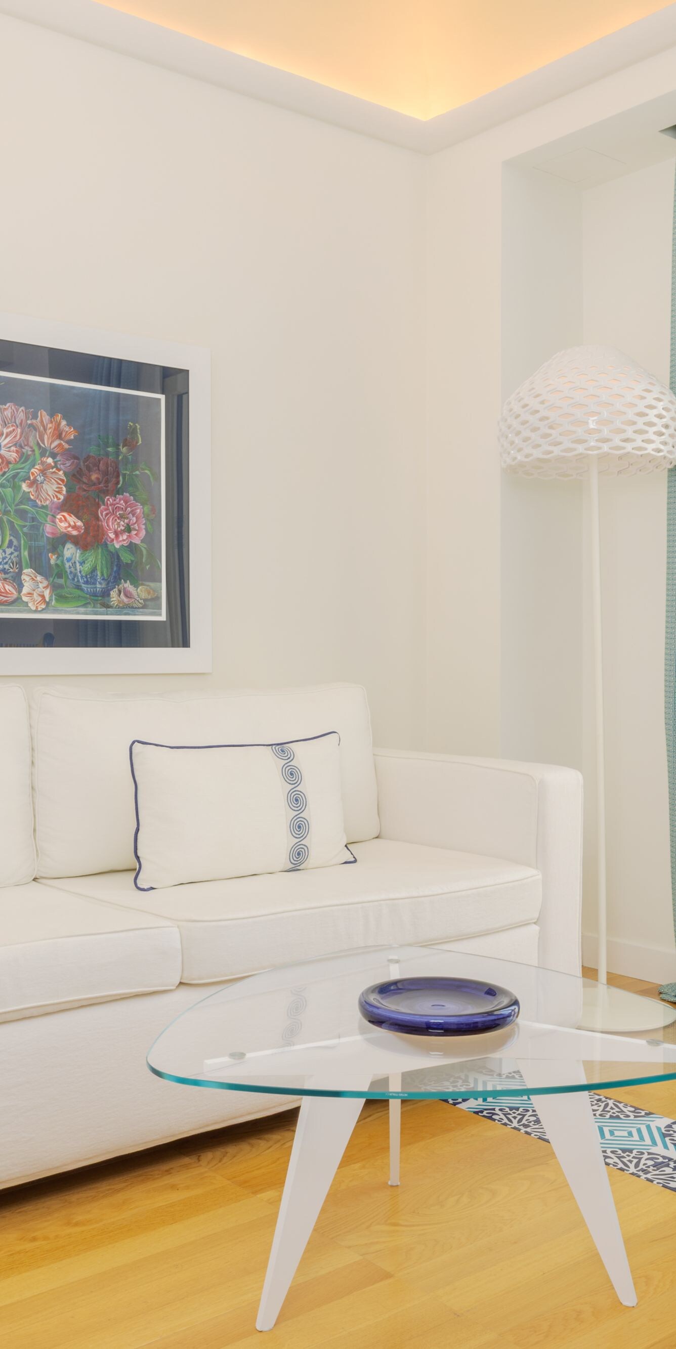 Bright sitting area with sofa, chair and balcony 